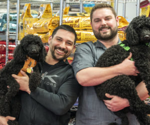 From left: Will Paul holds 4-year-old moyen poodle Zara while partner Branden Perreault holds Zara's 2-year-old sister, Kona, at The Animal House in Damariscotta on Saturday, April 25. Paul and Perreault bought the store at the beginning of April. (Bisi Cameron Yee photo)