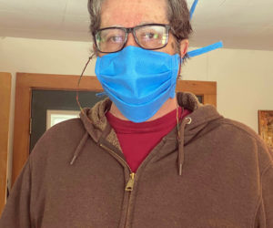 William "Zev" Keisch, of Damariscotta, wears one of the hand-sewn, medical-grade face masks he and a team of volunteers are making and distributing to essential workers in Lincoln County. (Photo courtesy Zev Keisch)