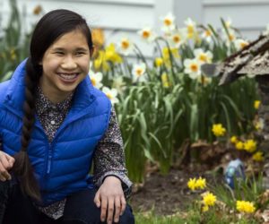 Yuji Smith, 12, smiles among the daffodils in Edgecomb on Friday, May 8. Smith recently donated 200 face masks to the Maine Veterans' Home in Augusta. (Bisi Cameron Yee photo)