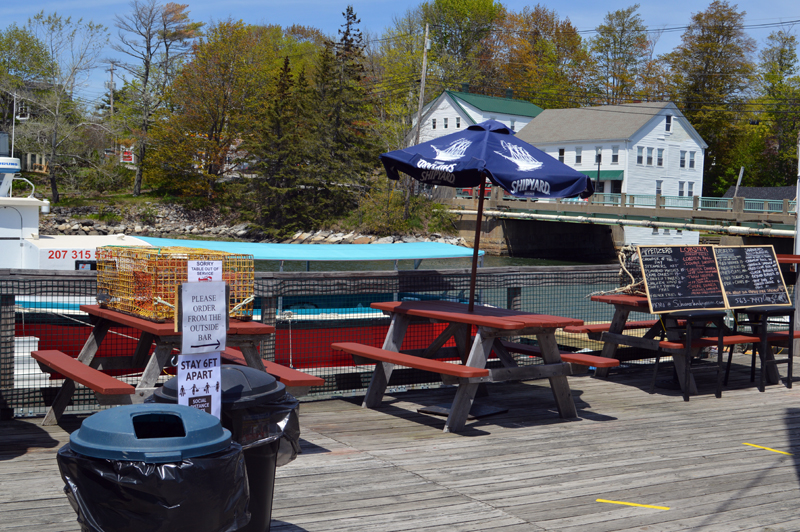 Lobster traps on tables, a simplified menu, and a full-service outdoor bar give diners the chance to eat out in a low-risk environment at Schooner Landing in Damariscotta. (Alyce McFadden photo)