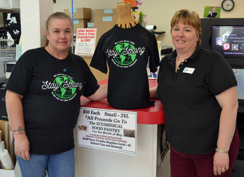 Mail It 4U co-owner Lynne Plourde (right) and customer service representative Sally Kenniston stand next to a mannequin wearing a Stay Strong T-shirt. The business is selling the T-shirts at its Newcastle and Bath locations, with 100% of the proceeds going to local food pantries.