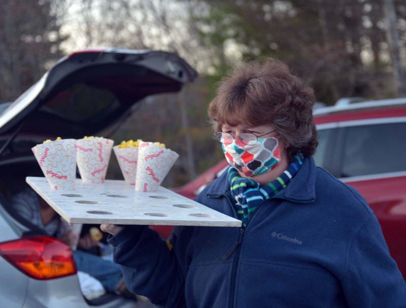 Doreen "Pooh" Moody delivers free popcorn at a makeshift drive-in theater in Nobleboro. (Paula Roberts photo)