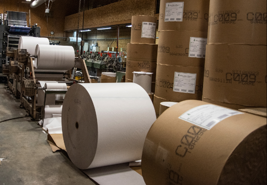 Large rolls of paper feed the press at The Lincoln County News in Newcastle on March 16. Everyone in the print shop pitches in when the presses run to ensure the print edition reaches newstands Wednesday afternoon. (Bisi Cameron Yee photo)