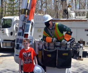 Max McCool poses with Central Maine Power Co. lineman Greg Haven at Max's home in Newcastle on Thursday, May 14. CMP presented McCool with thank-you gifts. (Paula Roberts photo)