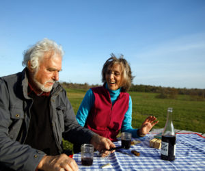 Herb Hartman and Lucy Martin enjoy the Charcuterie-To-Go Picnic Pack at one of Sheepscot General's picnic tables. (Photo courtesy of Kristin Dillon - Blue Horse Photography)