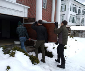 Davis and McMahon family members reinstall refurbished Waldo lobby doors. (Photo courtesy Josie Davis)