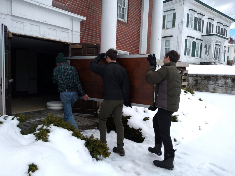 Davis and McMahon family members reinstall refurbished Waldo lobby doors.  (Photo courtesy Josie Davis)