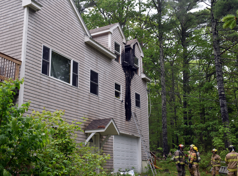 Firefighters assess the damage to a home at 99 Atwood Lane in Bristol after extinguishing a fire caused by a lightning strike the afternoon of Saturday, June 6. (Evan Houk photo)