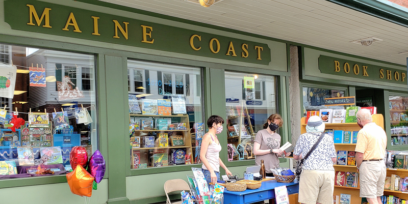 Sherman's Maine Coast Book Shop employees help customers during the first open-air market in downtown Damariscotta, Saturday, June 13. (Photo courtesy Jeff Friedman)