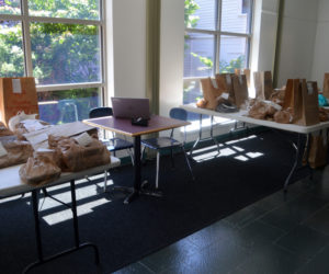 Bags of books await pickup in a hallway at Skidompha Library in Damariscotta. The library started offering curbside service Tuesday, June 16. (Alyce McFadden photo)