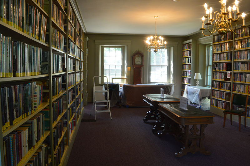 Furniture in the Wiscasset Public Library reading room is covered in plastic and pushed aside to discourage patrons from lingering. The library's full collection is open to the public for in-person browsing. (Alyce McFadden photo)