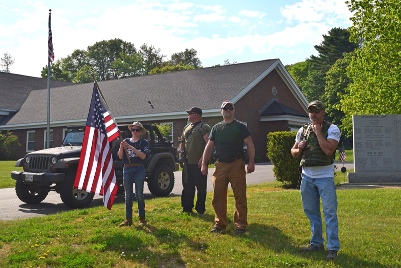 Counterprotesters stand silently across Route 1 from a demonstration at the Lincoln County Sheriff's Office in Wiscasset on Friday, June 5. (Hailey Bryant photo)