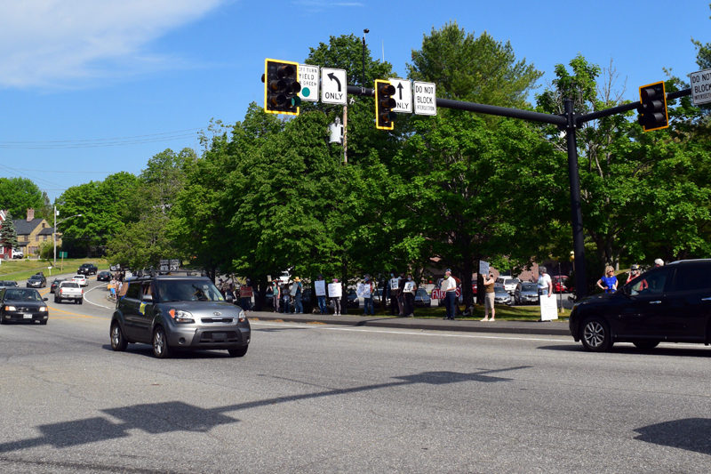 Protesters hold signs on the sidewalk near the Lincoln County Sheriff's Office, on Route 1 in Wiscasset, Friday, June 5. The demonstration was one of many around the world against racism and police brutality. (Hailey Bryant photo)