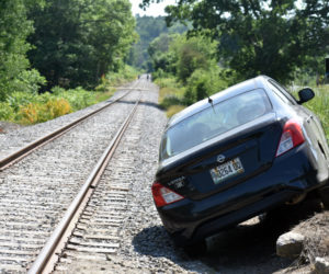 A Nissan Versa along the railroad tracks in Nobleboro after a crash, Tuesday, June 23. (Alexander Violo photo)
