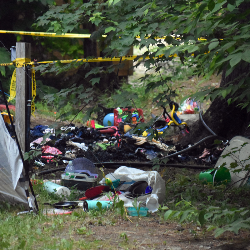 Caution tape warns bystanders away from the scene of a tent fire at Duck Puddle Campground on Wednesday, June 24. The tent and its contents were destroyed. (Alexander Violo photo)