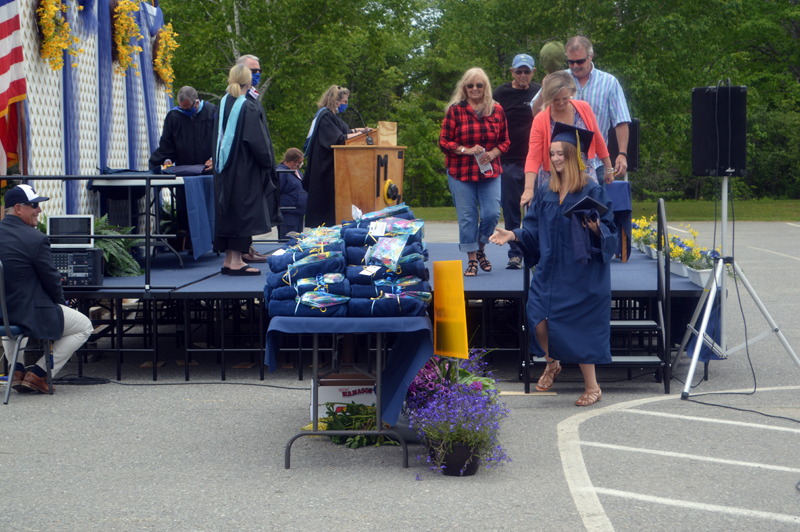 Lillian McCormick steps down from the graduation stage, followed by four family members, after receiving her diploma. (Alyce McFadden photo)