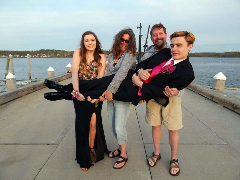 Connor McLean poses for a photo with his family on the occasion of his senior prom in 2019. From left: sister Maddie McLean, mom Elizabeth MacKenney, and stepfather Scott MacKenney. (Photo courtesy Elizabeth MacKenney)