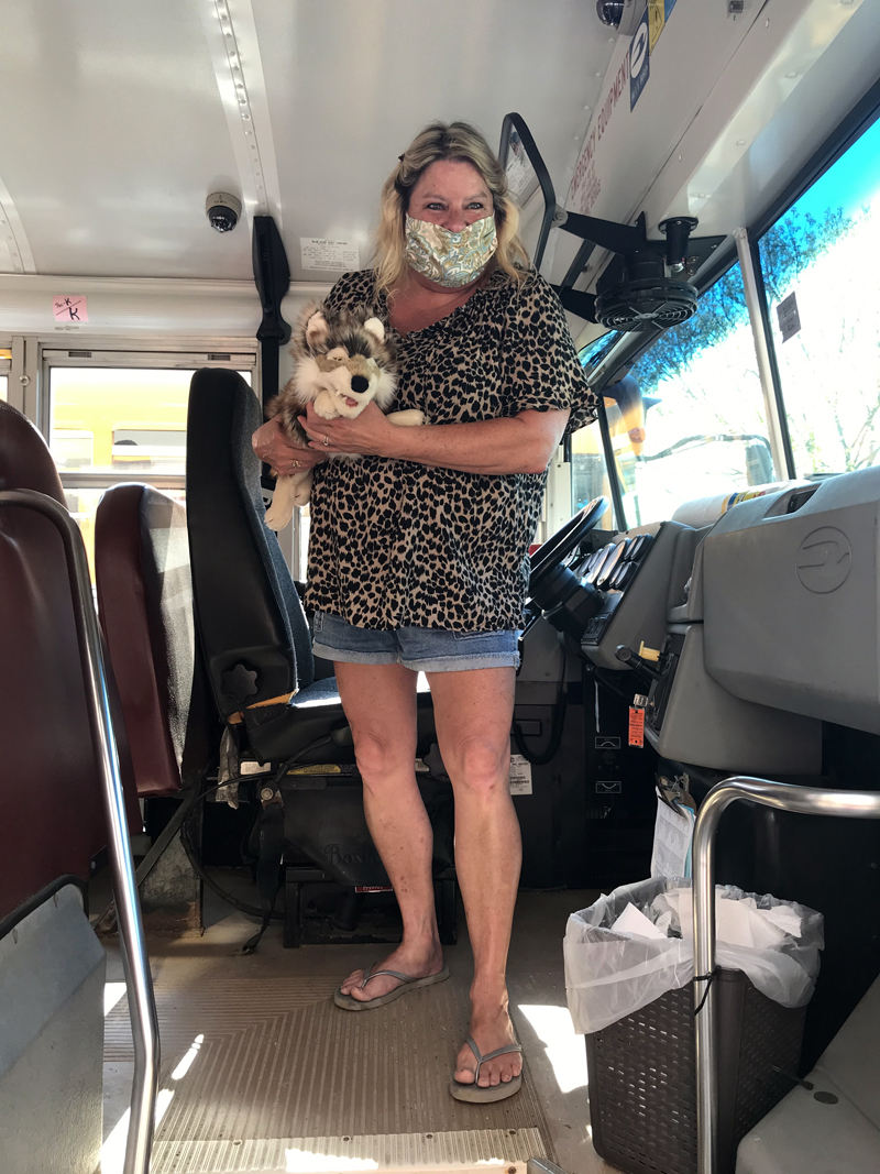 Wiscasset School Department bus driver Cathy Sherman holds Wolfie as she prepares to drive the puppet to a secret destination for the weekend. Young students use clues to find Wolfie each weekend. (Photo courtesy Carole Drury)