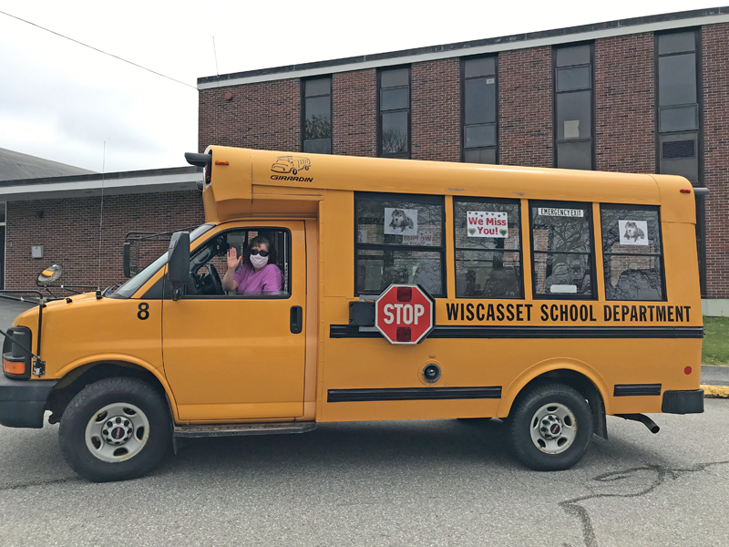 Wiscasset Elementary School music teacher Carole Drury waves from Wolfie's bus at the school. (Photo courtesy Carole Drury)