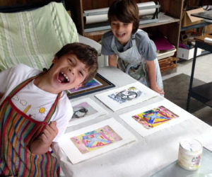 Two students of Midcoast Printmakers enjoy their time in the studio.