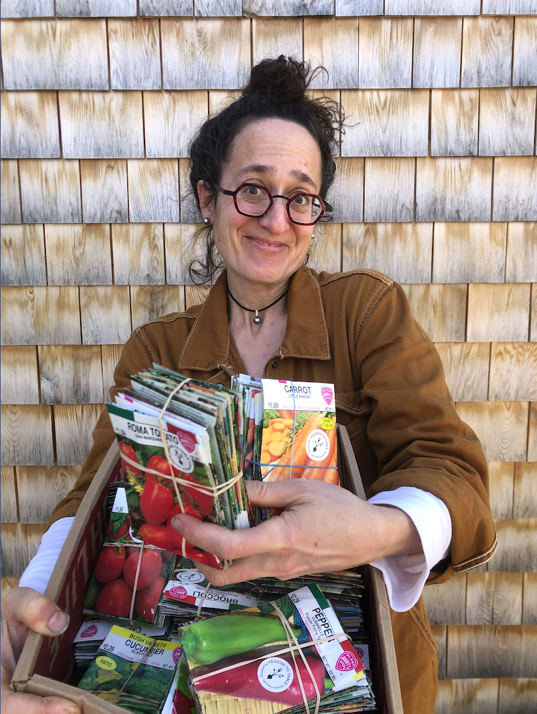 Erica of Veggies to Table readies a basket of seedlings to be delivered to local families.