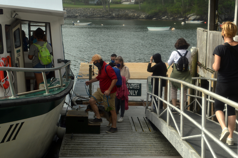 Human and canine passengers board the Hardy III for ferry service to Monhegan Island at the dock in New Harbor on Thursday, July 2. Hardy Boat Cruises has a cap on 43% of capacity to allow for physical distancing. (Alyce McFadden photo)