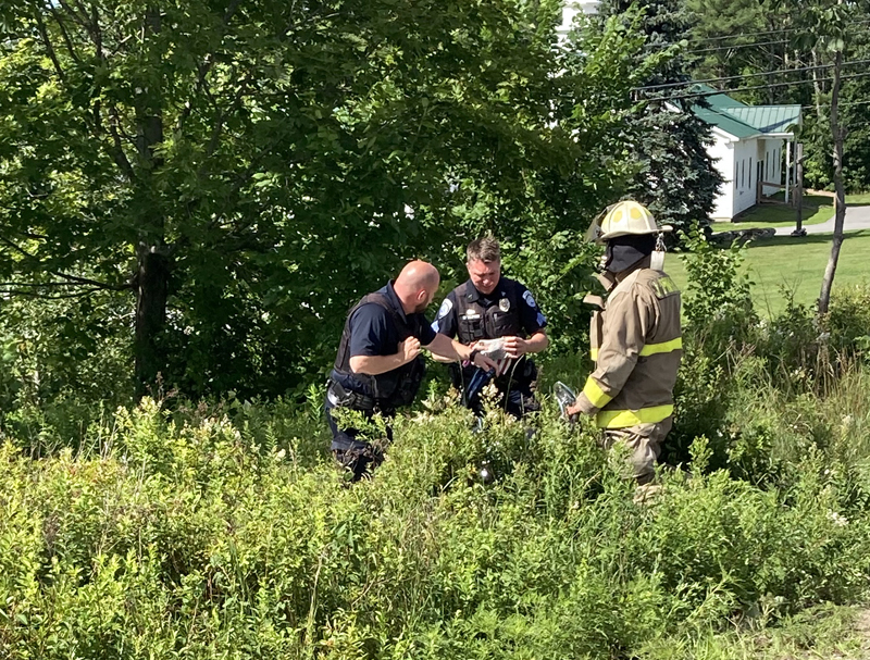 Damariscotta police and fire officers work at the scene of a motorcycle crash on Main Street in Damariscotta the afternoon of Wednesday, July 15. Both occupants of the motorcycle suffered severe injuries, police said. (Maia Zewert photo)