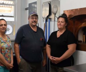The business partners behind The Village Grill Co. in Damariscotta stand in front of the roadside eatery's new $25,000 Le Panyol wood-fired oven, Monday, July 6. From left: Missy Crockett, Paul Blomquist, and Tricia Spinney. (Evan Houk photo)
