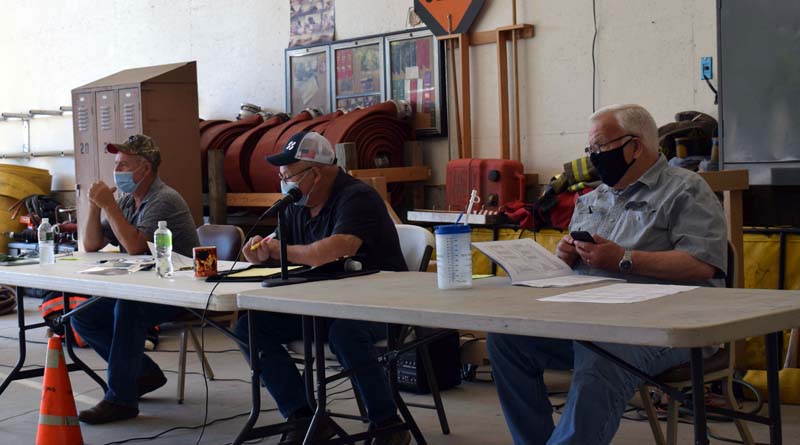 The Dresden Board of Selectmen presides over annual town meeting in the fire station the morning of Saturday, July 18. From left: Third Selectman Allan Moeller, Second Selectman Gerald Lilly, and First Selectman John Rzasa. (Evan Houk photo)