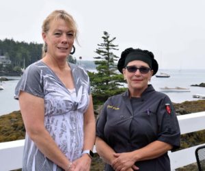 Lynette McGowan, the new owner of Coveside Restaurant and Marina, stands with the new head chef, Doris Rodriguez, on the front deck overlooking Christmas Cove, Friday, July 10. (Evan Houk photo)