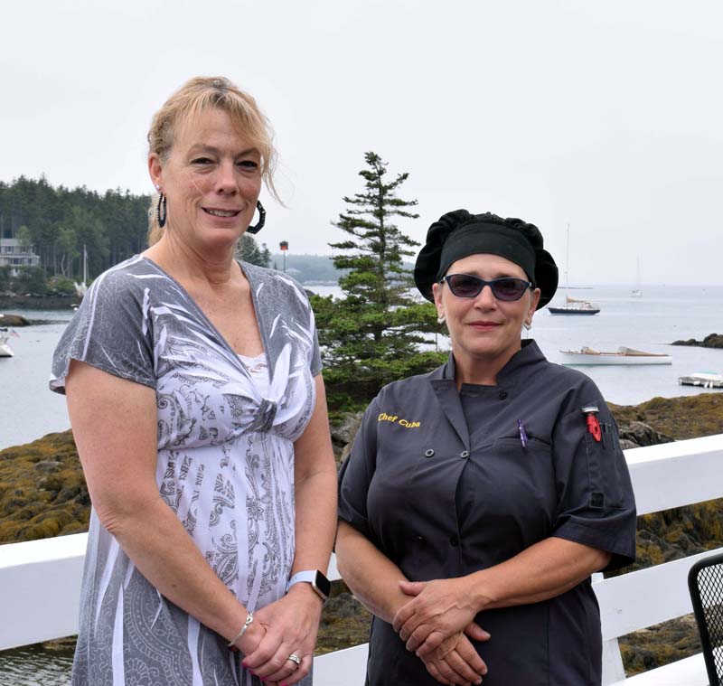 Lynette McGowan, the new owner of Coveside Restaurant and Marina, stands with the new head chef, Doris Rodriguez, on the front deck overlooking Christmas Cove, Friday, July 10. (Evan Houk photo)