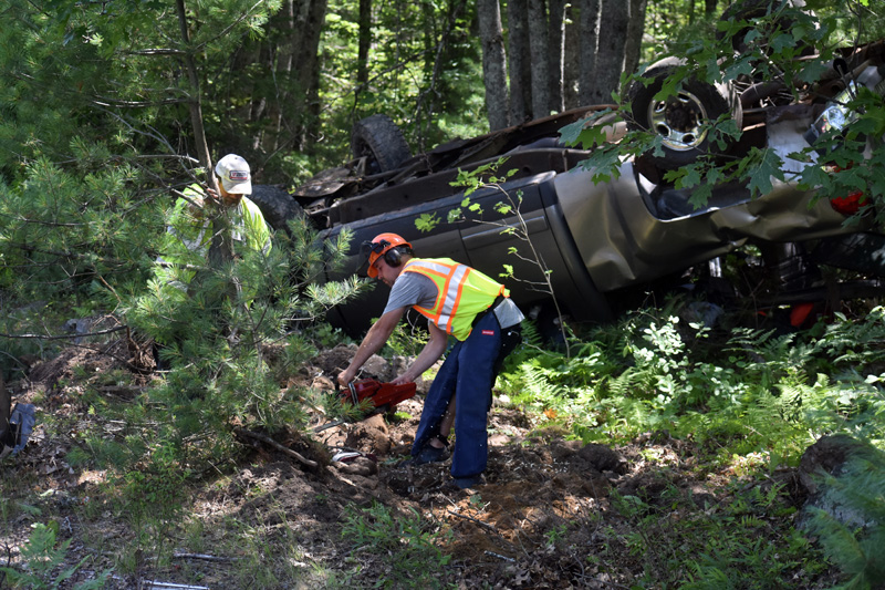 A tree is cut to clear the way for the removal of a pickup after a rollover on Route 17 in Somerville, Monday, July 20. (Alexander Violo photo)