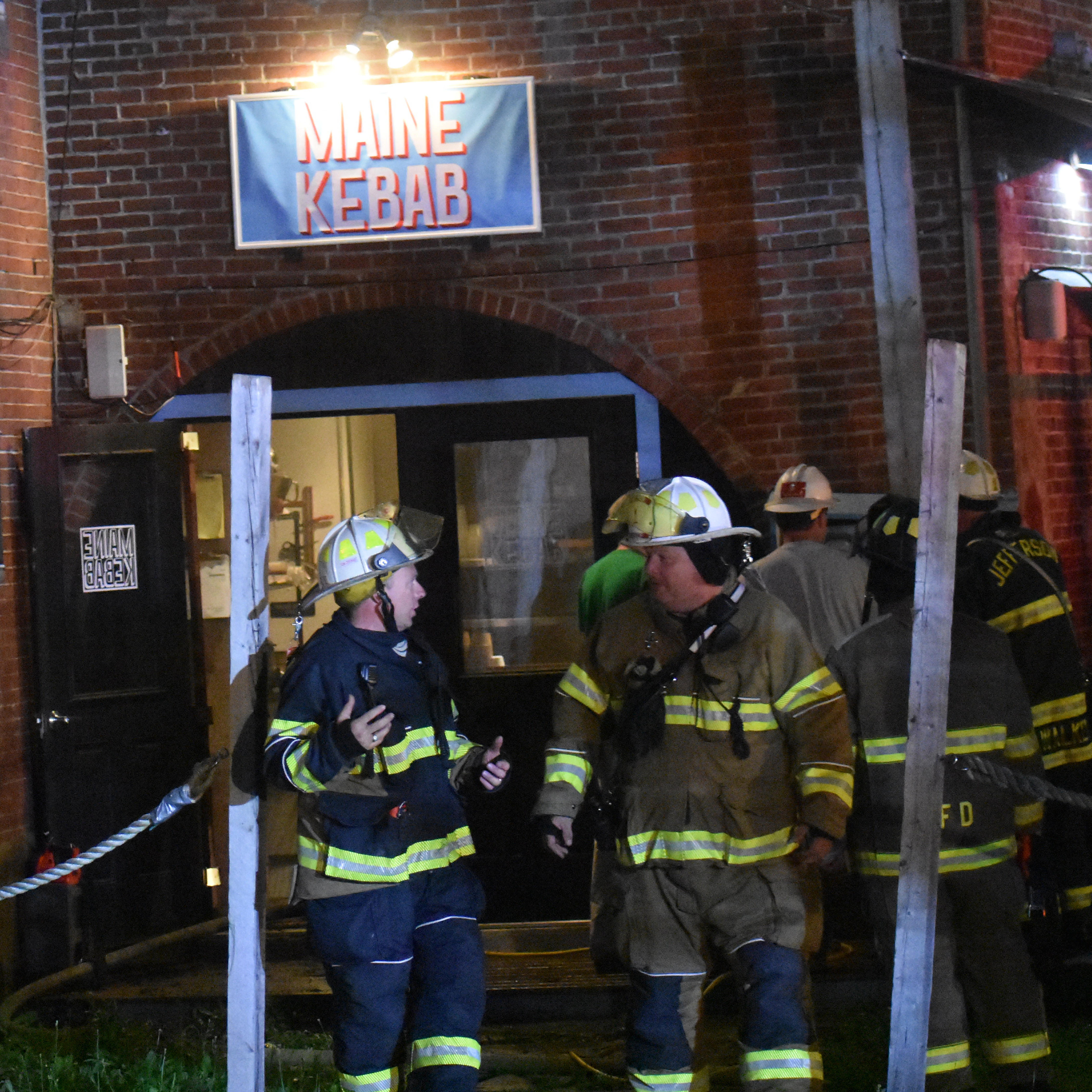 Firefighters on the back side of 9 Friendship St. in Waldoboro, following a fire at Maine Kebab, Wednesday, July 23. (Alexander Violo photo)