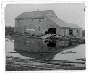 An 1896 photo of the Mill at Pemaquid Falls shows a nine-over-six window next to the ramp which was used to pull logs through the open door. (Photo courtesy Chuck Rand)