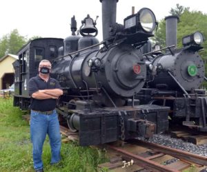 Wiscasset, Waterville & Farmington Railway Museum President David Buczkowski wears a WW&F face mask as he stands in front of Engines 4 and 8. (Paula Roberts photo)