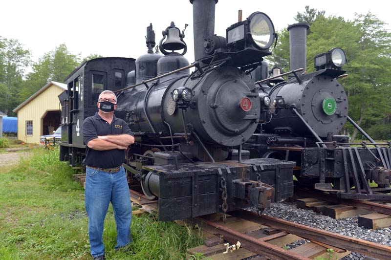 Wiscasset, Waterville & Farmington Railway Museum President David Buczkowski wears a WW&F face mask as he stands in front of Engines 4 and 8. (Paula Roberts photo)