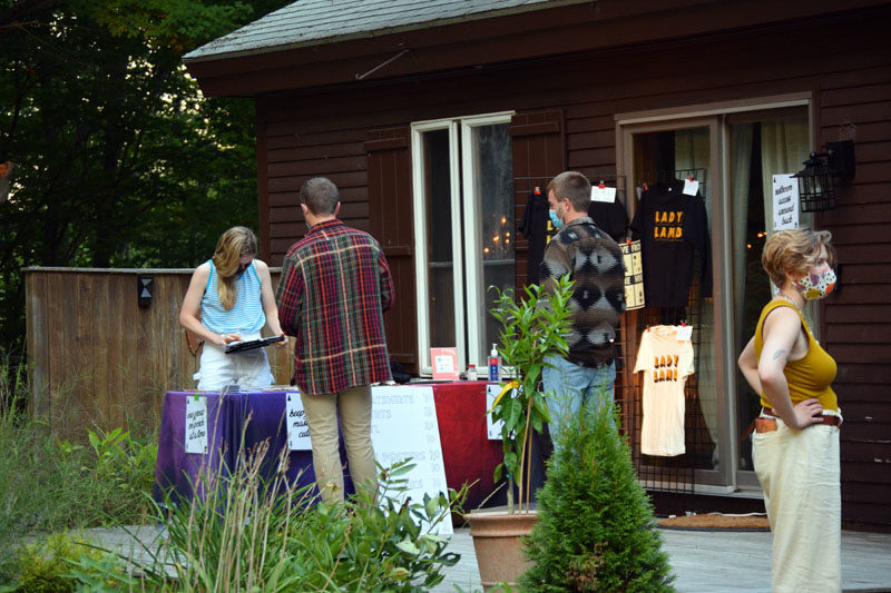 Aly Spaltro's girlfriend, Erica Peplin, sells merchandise from a stand on the porch. (Hailey Bryant photo)