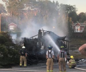 Firefighters hose down the remains of a garage at 2367 State Route 129 in South Bristol early Saturday, Aug. 1. (Hailey Bryant photo)