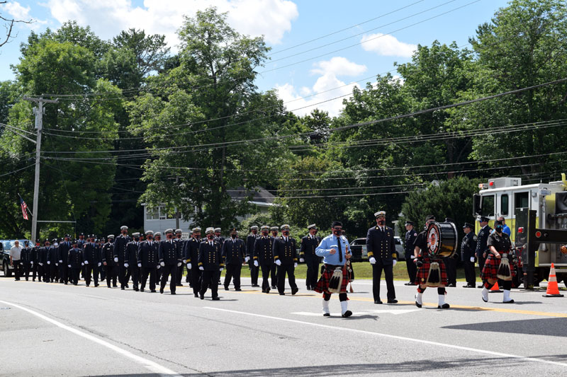 The Bergen County Firefighters Pipe Band and the Hackensack Fire Department, both of New Jersey, march on Route 1 in Wiscasset to honor Hackensack firefighter Richard Kubler. Kubler, 53, of Wiscasset, died July 25 of cancer linked to his service at ground zero after the 9/11 terrorist attacks. (Hailey Bryant photo)