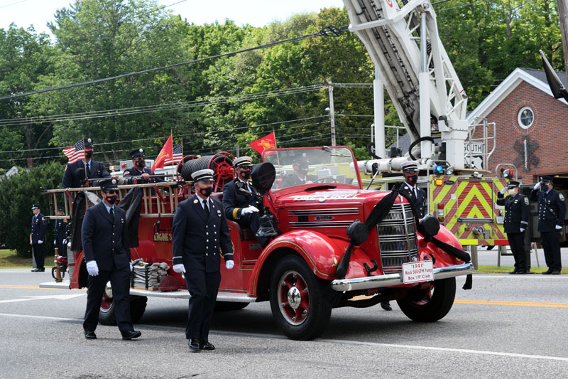 Black bunting covers the lights of an antique fire truck during a procession in honor of firefighter Richard Kubler on Route 1 in Wiscasset, Saturday, Aug. 1. (Hailey Bryant photo)