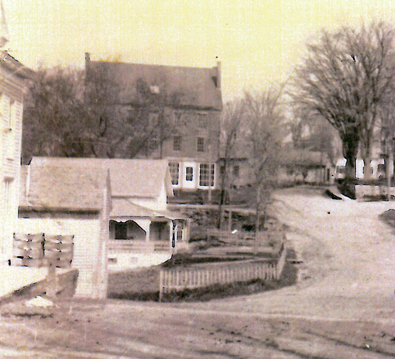 The Dray house with its porch and wooden fence. When the state widened the road and built a new bridge in 1952, the house was moved to Mills Road. (Photo courtesy Newcastle Historical Society Museum)