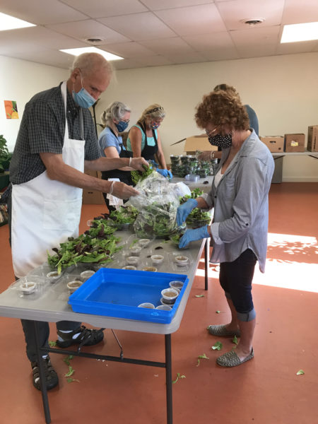 Volunteers pack lasagna and salads made with local ingredients for Waldoboro Food Pantry.