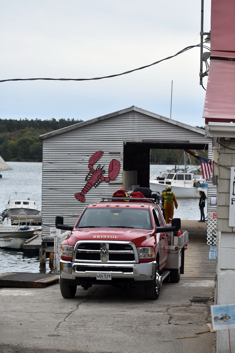 A Bristol fire truck at Broad Cove Marine Services in Bremen on Tuesday, Sept. 22. Firefighters from Bremen, Bristol, Damariscotta, and the Maine Forest Service crossed Hockomock Channel to fight a brush fire on Bremen Long Island. (Alexander Violo photo)