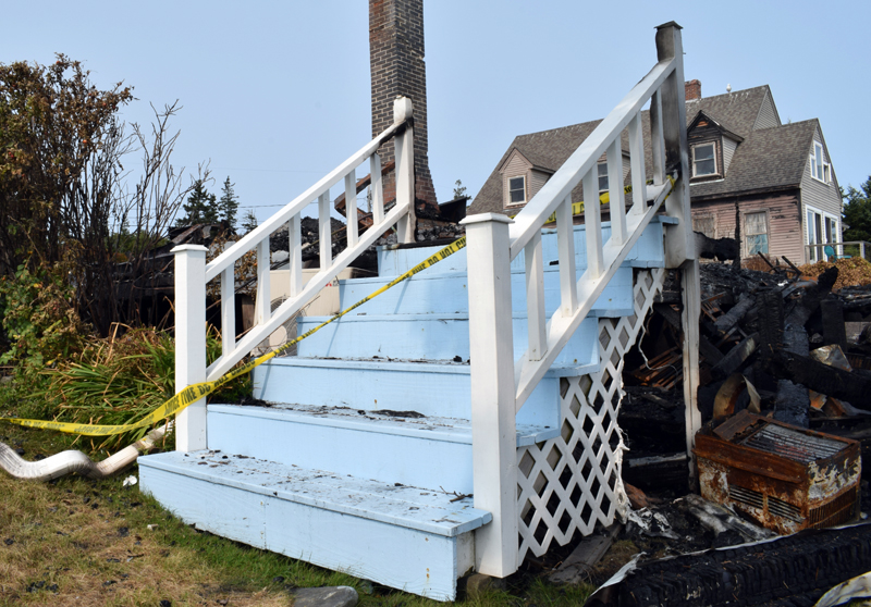 The staircase to the dining room of the Seagull Shop was one of the only things to survive the fire Wednesday, Sept. 9. Co-owner Tim Norland said the staircase was a favorite spot for parents to take pictures of their children throughout the years and he plans to incorporate it into the new building. (Evan Houk photo)