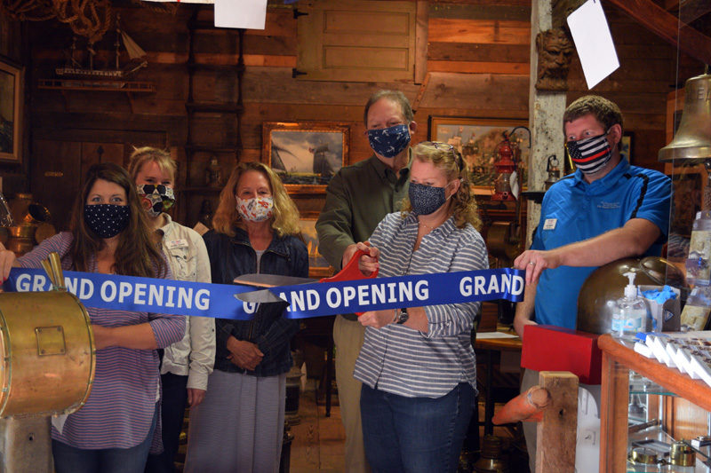 The owners of Skipjack Marine Gallery and representatives of the Damariscotta Region Chamber of Commerce cut the ribbon for the new business in Round Pond on Friday, Sept. 11. From left: chamber representatives Kristy Battles, Jeniffer Cooley, and Lisa Hagen; owners Joe and Alison Elder; and chamber President John Roberts. (Hailey Bryant photo)