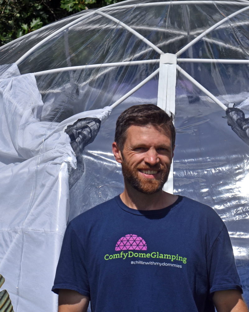 ComfyDome owner Seth Fraser in front of one of the three domes guests can rent on his property in Jefferson. (Alexander Violo photo)