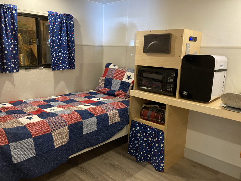 The interior of a Veterans Emergency Temporary Shelter trailer. Each shelter comes with a bed, microwave, refrigerator, commode, and heater. (Hailey Bryant photo)