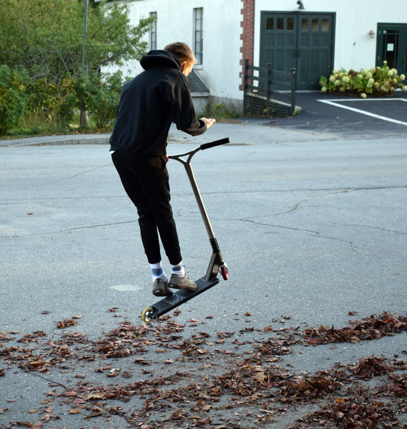 Rowan Donaghy, 13, does a trick on a scooter near the corner of Hodgdon and Church streets in Damariscotta on Monday, Oct. 5. (Evan Houk photo)