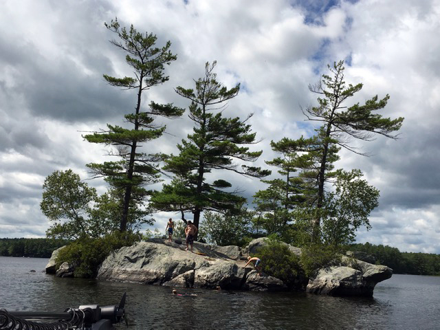 Kids explore the rocks of a small island in Biscay Pond. (Photo courtesy Mary Berger)