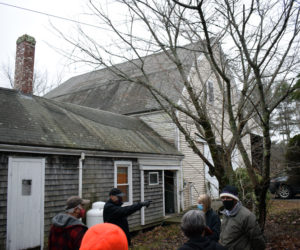 Michael Noetzel (pointing) explains his renovation plans for 639 Main St. to the Damariscota Planning Board and others during a site visit on Monday, Dec. 14. Noetzel is applying to open a recreational cannabis storefront and Tier 2 cultivation facility at the location. (Evan Houk photo)